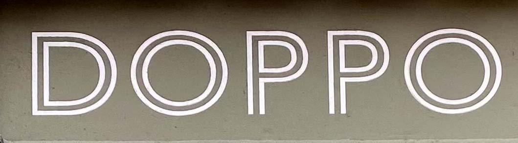 Sign at Doppo restaurant on London's Dean Street in Soho
