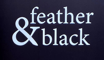 Sign at Feather and Black store on Tottenham Court Road in London