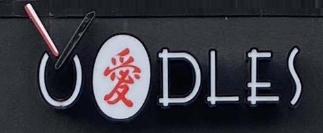 Oodles restaurant sign on Brick Lane in London