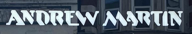 Sign at Andrew Martin furniture store on Tottenham Court Road in London