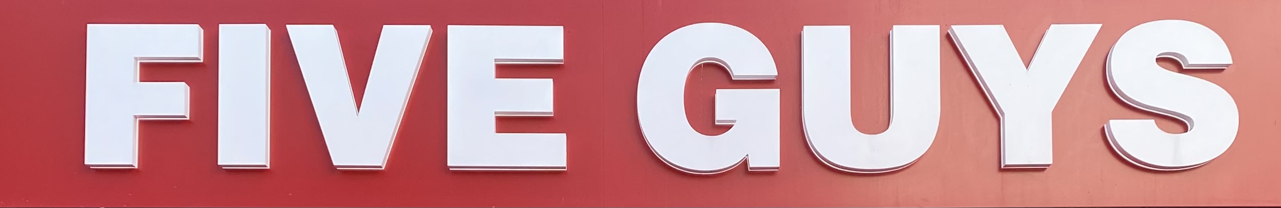 Sign at Five Guys burger restaurant on London's Queensway