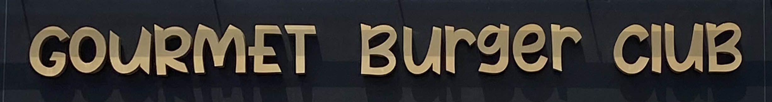 Sign at Gourmet Burger Club restaurant on Strand in London