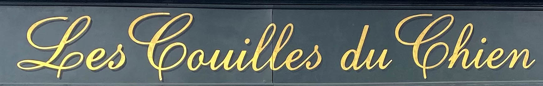 Les Couilles du Chien shop sign on Golborne Road