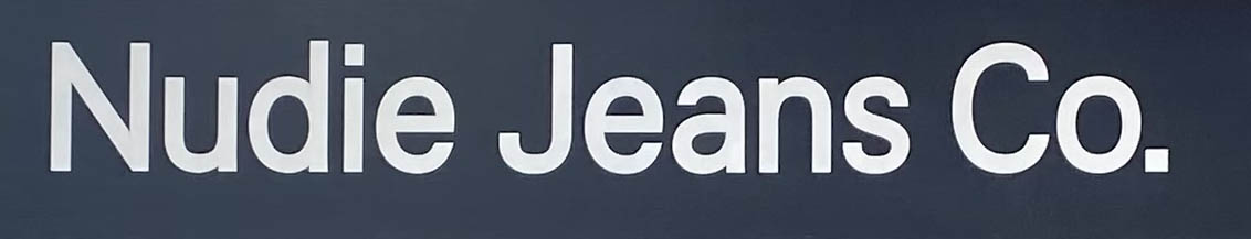 Nudie Jeans Co shop sign on D'Arblay Street in London's Soho