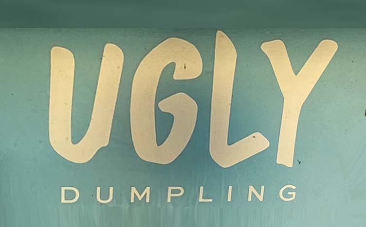 Sign at Ugly Dumpling restaurant on corner of Ganton Street in London