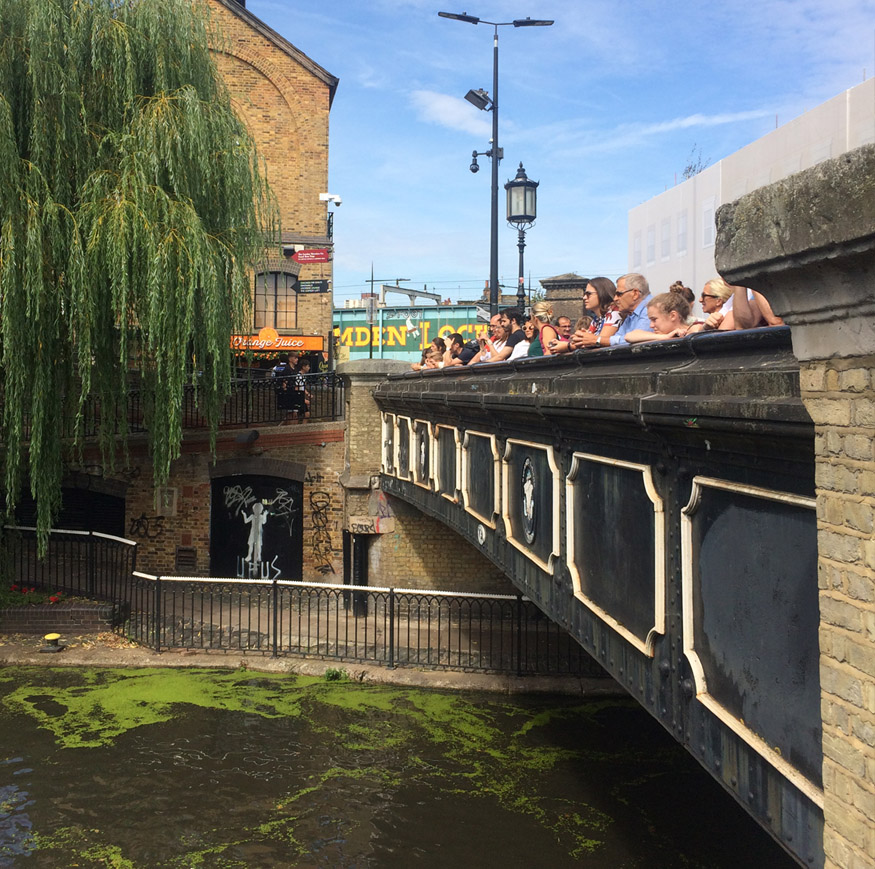 Spectators on the canal bridge in London's Camden