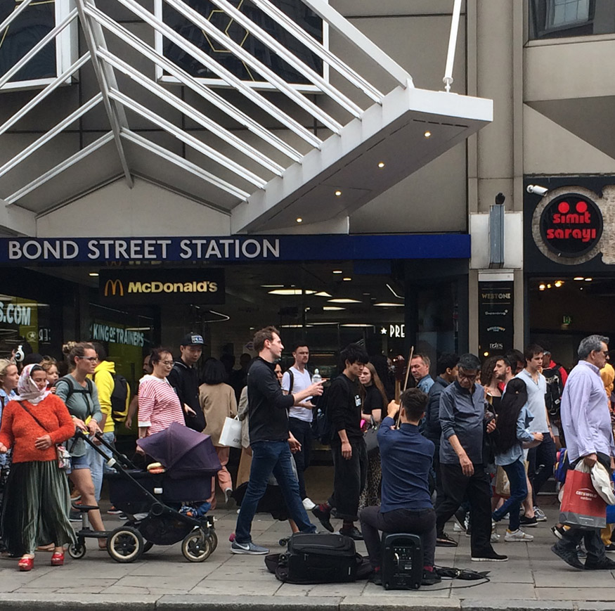 Saturday shoppers on London's Oxford Street outside Bond Street station